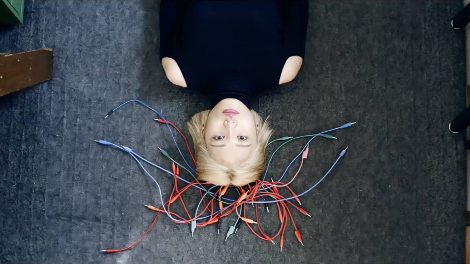 A woman looking up through cables.